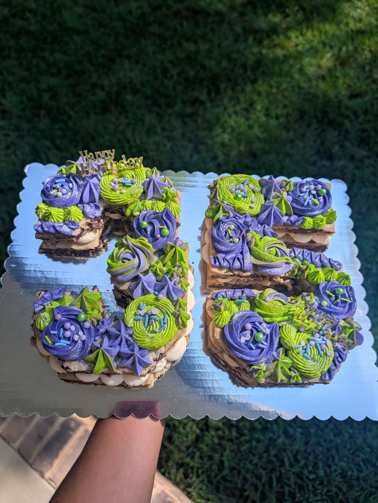 Number cookie cake with purple and lime green rosettes